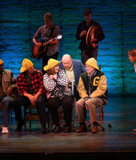 The cast of Come From Away performing onstage